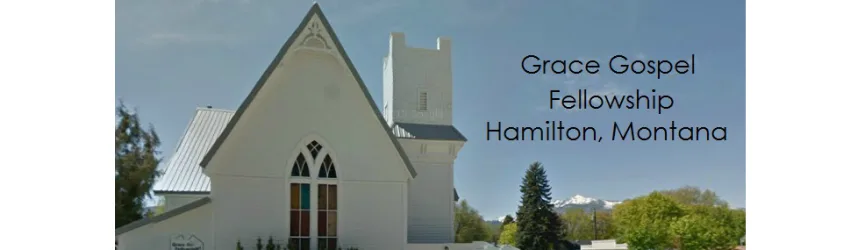 Grace Gospel Fellowship church building in Hamilton, Montana, with snow-capped mountains in the distance